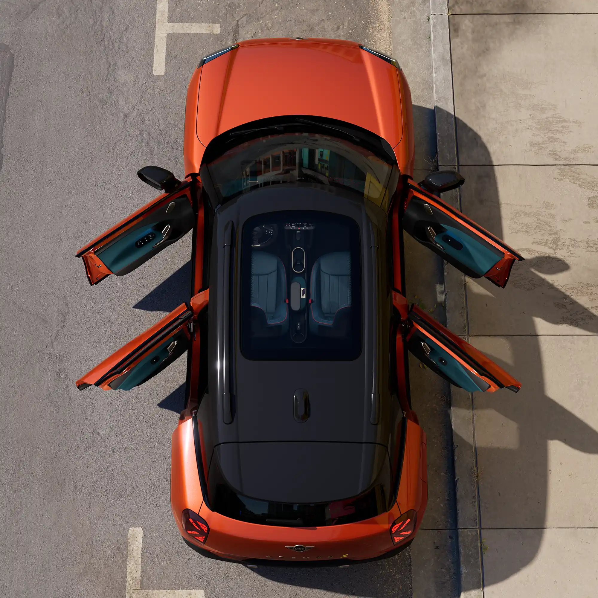 Top view of parking all-electric MINI Aceman in orange with open doors and sunroof