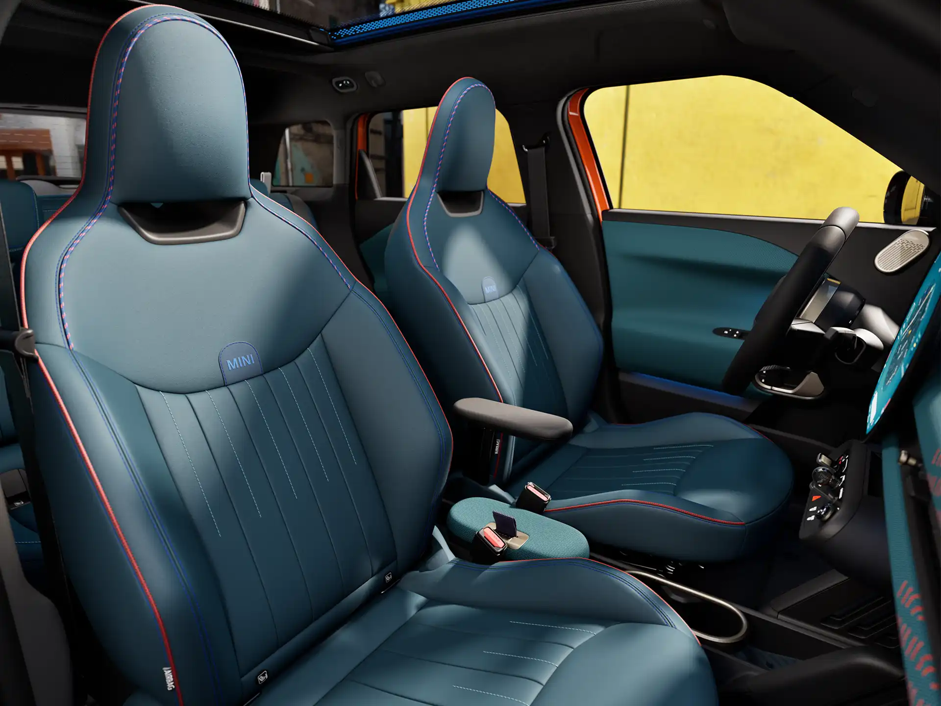 Interior perspective of the all-electric MINI Aceman is showing the dashboard, steering wheel, round display, panorama glassroof  and back of the frontseats