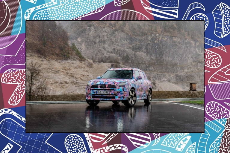 Side view of the MINI Countryman driving on the road. 