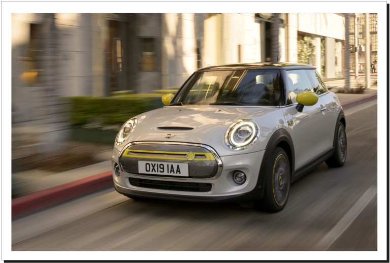 Side front view picture of a MINI Cooper SE on a road. 
